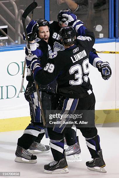 Martin St. Louis celebrates his third period goal with Steven Stamkos and Mike Lundin of the Tampa Bay Lightning in Game Six of the Eastern...