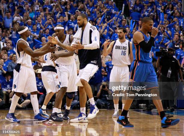 Jason Terry, Brendan Haywood and Tyson Chandler of the Dallas Mavericks react on the court in the third quarter as Russell Westbrook of the Oklahoma...