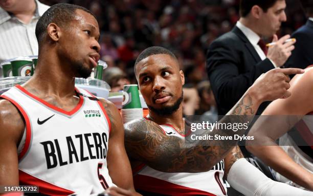 Damian Lillard speaks with Rodney Hood of the Portland Trail Blazers during a timeout during the second half of game three of the Western Conference...