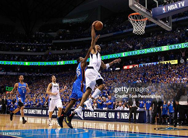 Shawn Marion of the Dallas Mavericks dunks the ball as he is fouled by Kevin Durant of the Oklahoma City Thunder late in the fourth quarter in Game...