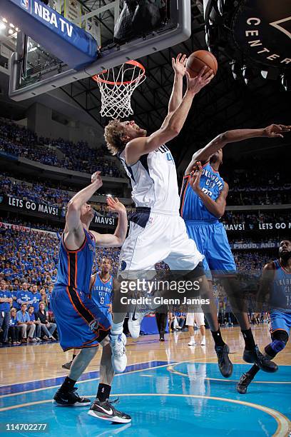 Dirk Nowitzki of the Dallas Mavericks shoots against Nick Collison and Kevin Durant of the Oklahoma City Thunder during Game Five of the Western...