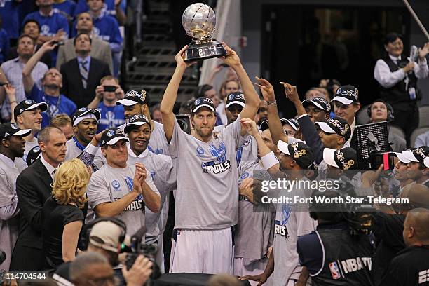 Dallas Mavericks' Dirk Nowitzki hoists the championship trophy at American Airlines Center in Dallas, Texas, on Wednesday May 25 in Game 5 of the...