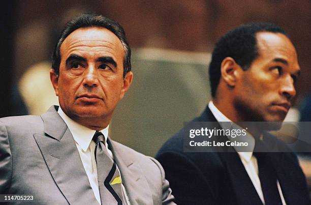 Defense attorney Robert Shapiro sits next to O.J. Simpson during a preliminary hearing following the murders of Simpson's ex-wife Nicole Brown...