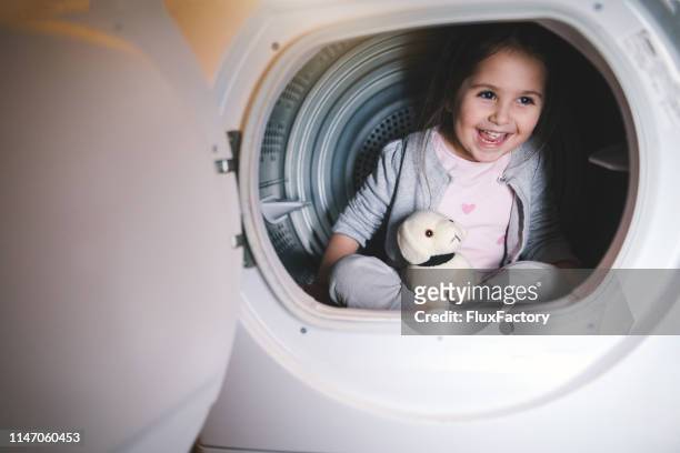 cute child playing in a washing machine - dog washing machine stock pictures, royalty-free photos & images
