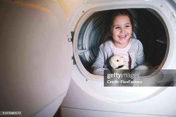 cheerful child having fun at home in a washing machine - dog washing machine stock pictures, royalty-free photos & images