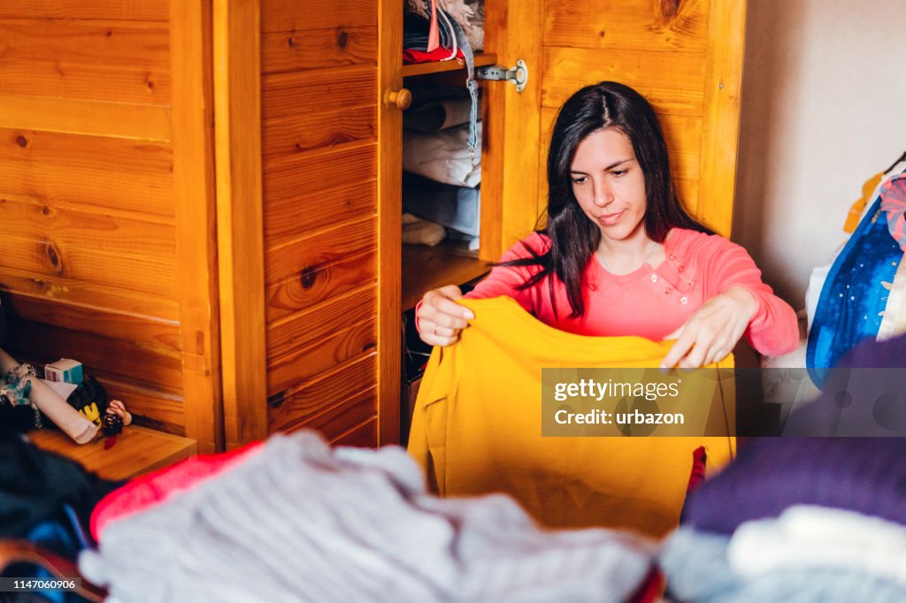 To Sort Out Woman Sorting Out Wardrobe High-Res Stock Photo - Getty Images