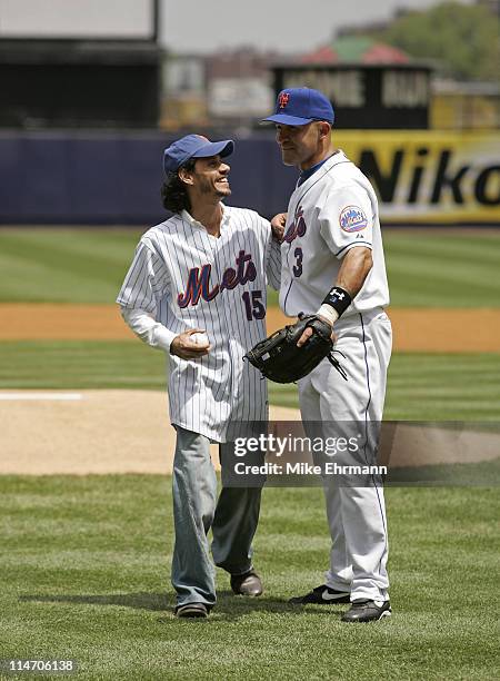 Singer Marc Anthony throws out the first pitch with Miguel Cairo before a subway series game between the New York Mets and the New York Yankees at...