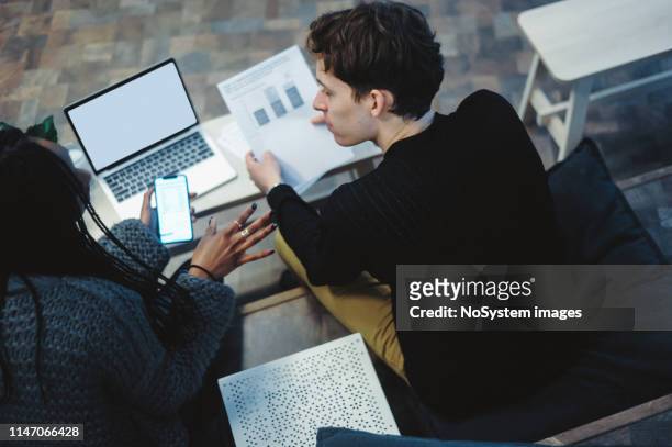 young couple brainstorming their finances, savings and investments - bonding stock pictures, royalty-free photos & images