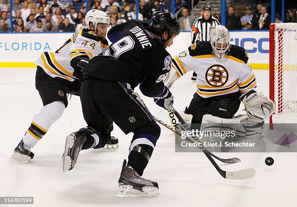 Dennis Seidenberg and Tim Thomas of the Boston Bruins defend against Steve Downie of the Tampa Bay Lightning in Game Six of the Eastern Conference...