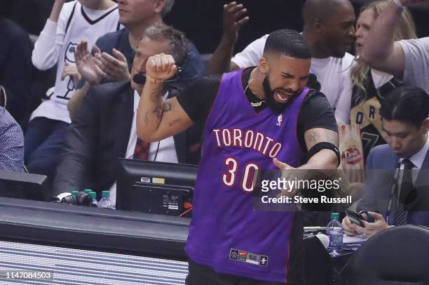 Drake wears a Stephen Curry Raptors jersey as the Toronto Raptors play the Golden State Warriors in game One of the NBA Finals in Toronto. May 30,...