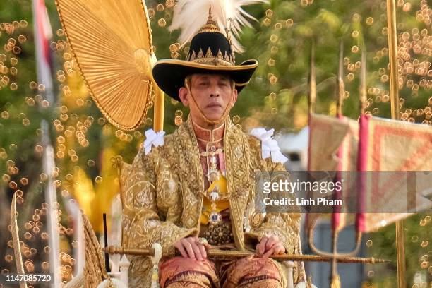 Thailand's newly crowned King Maha Vajiralongkorn is carried in a golden palanquin during the coronation procession on May 5, 2019 in Bangkok,...