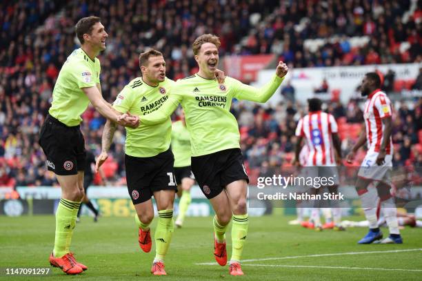 Kieran Dowell of Sheffield United celebrates as he scores his team's first goal with Billy Sharp and Chris Basham during the Sky Bet Championship...