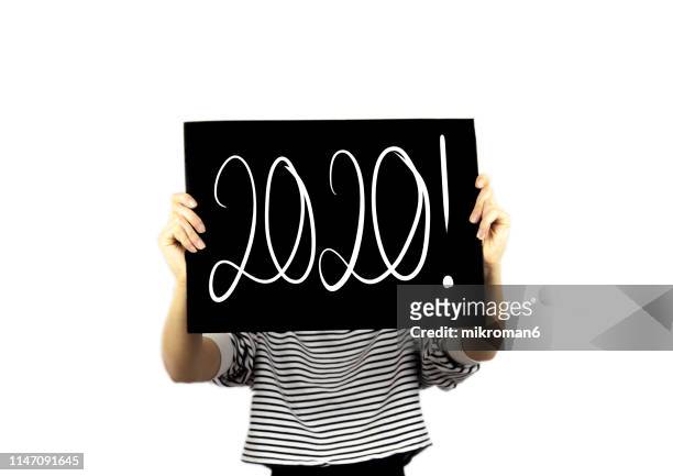 hand writing 2020 new year with chalk in black board - new years eve 2019 stock pictures, royalty-free photos & images