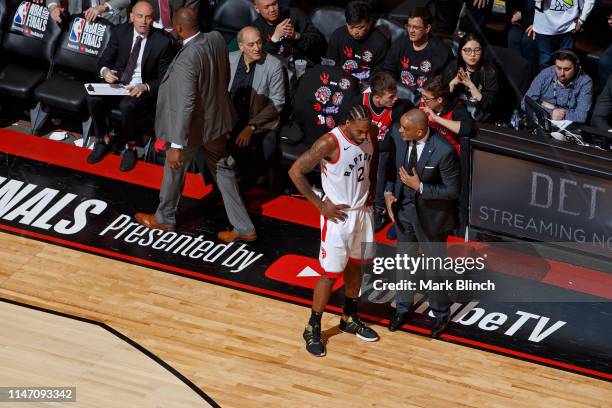 Phil Handy and Kawhi Leonard of the Toronto Raptors talk during Game One of the NBA Finals against the Golden State Warriors on May 30, 2019 at...