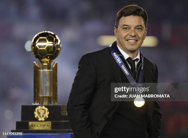 Argentina's River Plate coach Marcelo Gallardo gestures next to the trophy of the Recopa Sudamericana after winning 3-0 the final football match...