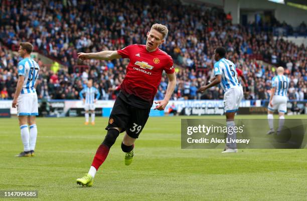 Scott McTominay of Manchester United celebrates after scoring his team's first goal during the Premier League match between Huddersfield Town and...
