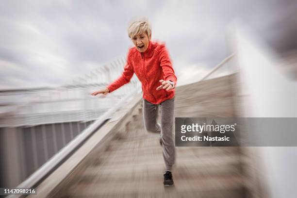 senior woman falling down stone steps outdoors - falling stock pictures, royalty-free photos & images