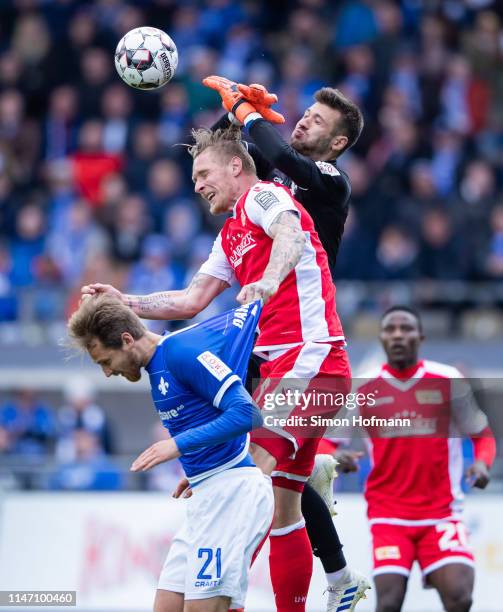 Goalkeeper Daniel Heuer Fernandes of Darmstadt tries to make a save against Sebastian Polter of Berlin during the Second Bundesliga match between SV...