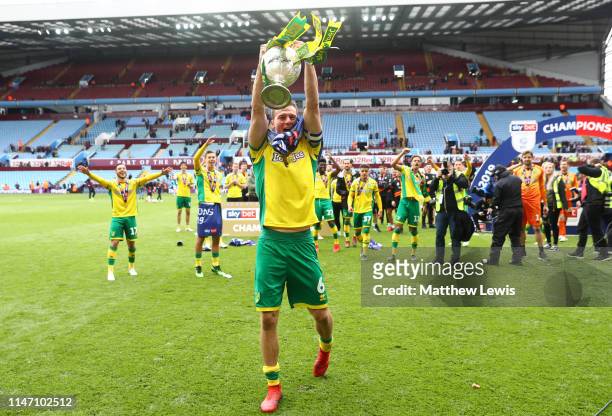 Christoph Zimmermann of Norwich City lifts the championship trophy in celebration after the Sky Bet Championship match between Aston Villa and...