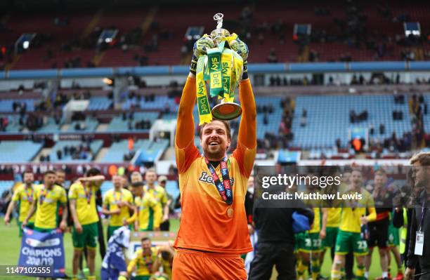 Tim Krul of Norwich City lifts the championship trophy in celebration after the Sky Bet Championship match between Aston Villa and Norwich City at...