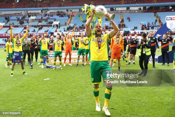 Teemu Pukki of Norwich City lifts the championship trophy in celebration after the Sky Bet Championship match between Aston Villa and Norwich City at...