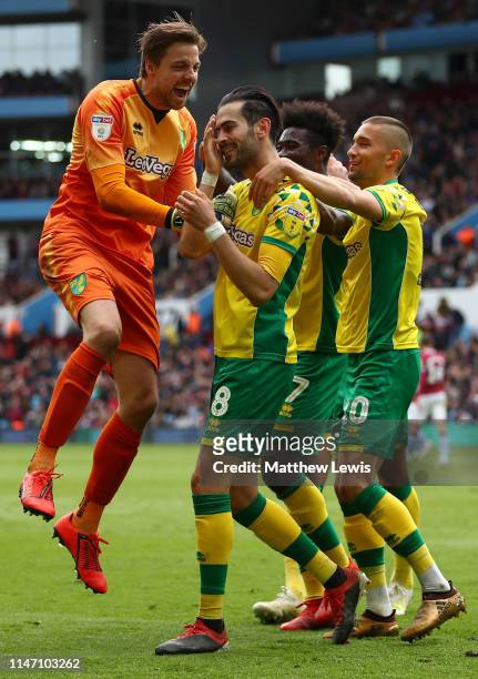 Mario Vrancic of Norwich City celebrates after scoring his team's second goal with team mates during the Sky Bet Championship match between Aston...
