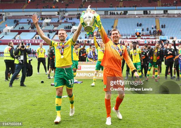 Jordan Rhodes and Michael McGovern of Norwich City lift the championship trophy in celebration after the Sky Bet Championship match between Aston...