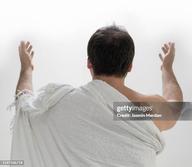 muslim male pilgrim praying - mecca stock pictures, royalty-free photos & images