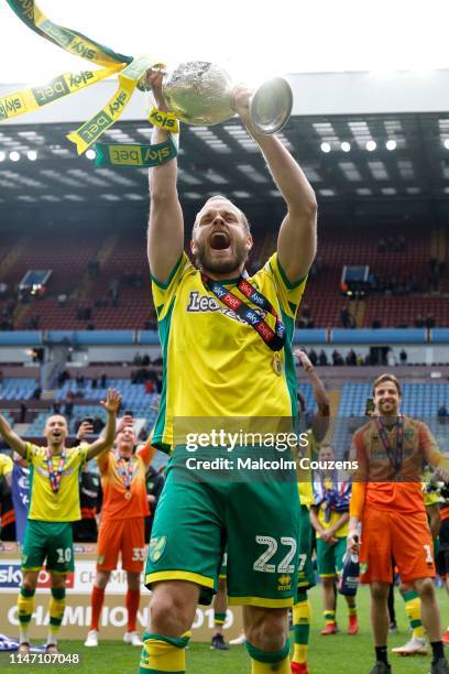 Teemu Pukki of Norwich City lifts the Championship trophy following the Sky Bet Championship game between Aston Villa and Norwich City at Villa Park...