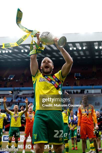 Teemu Pukki of Norwich City lifts the Championship trophy following the Sky Bet Championship game between Aston Villa and Norwich City at Villa Park...