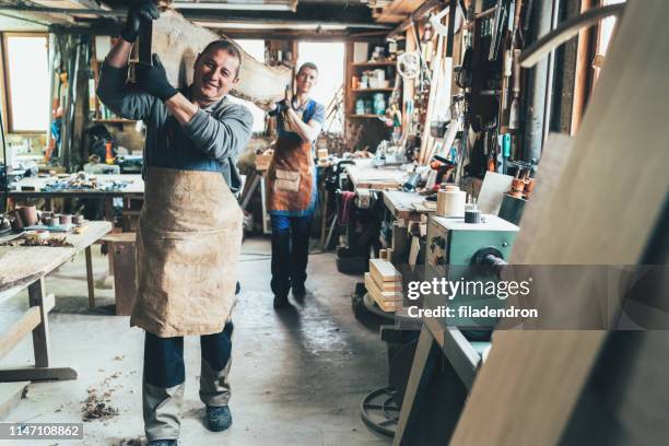 carpenters carrying a wooden plank - family business generations imagens e fotografias de stock