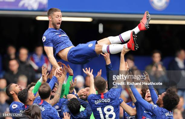 Gary Cahill of Chelsea is thrown in the air by team mates in celebration after the Premier League match between Chelsea FC and Watford FC at Stamford...