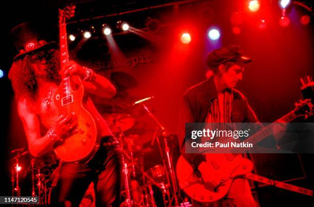 British-American Rock musician Slash plays guitar as he performs with his group, Slash's Snakepit, along with special guest Izzy Stradlin , onstage...