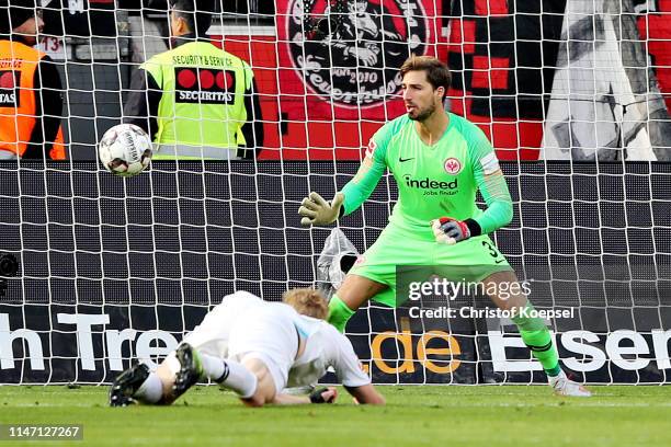 Kevin Trapp of Eintracht Frankfurt looks on as teammate Martin Hinteregger scores an own goal, the sixth goal for Bayer 04 Leverkusen during the...