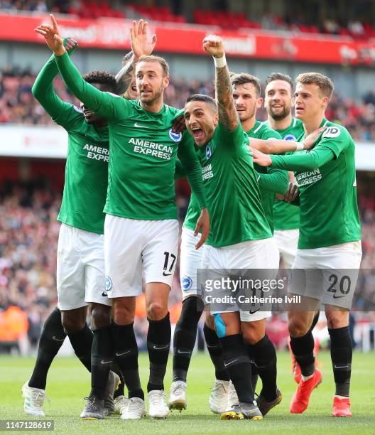Glenn Murray of Brighton and Hove Albion celebrates with teammates after scoring his team's first goal from the penalty spot during the Premier...