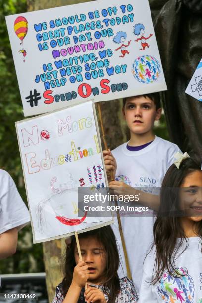 Child holds a placard during the demonstration. Children and their families were protesting to demand action to address the crisis in education for...