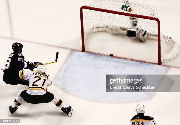 Martin St. Louis of the Tampa Bay Lightning scores a second period goal past Andrew Ference and Mark Recchi of the Boston Bruins in Game Six of the...