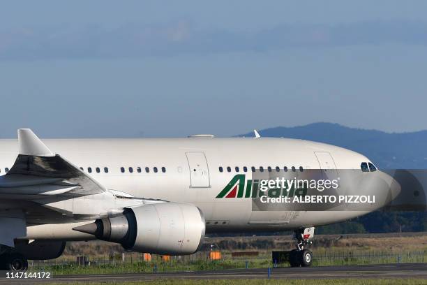 An Airbus A320 bearing the livery of Alitalia airline taxies on the tarmac prior taking off from Rome's Fiumicino airport on May 31, 2019.