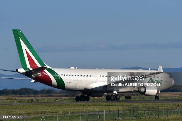 An Airbus A320 bearing the livery of Alitalia airline taxies on the tarmac prior taking off from Rome's Fiumicino airport on May 31, 2019.