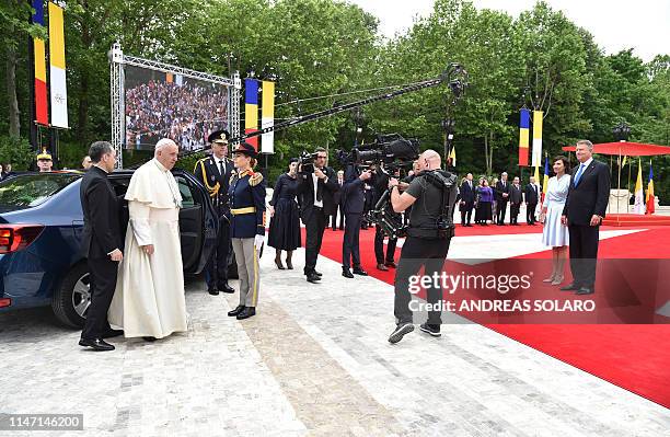 Romania's President Klaus Iohannis and his wife Carmen Iohannis wait to welcome Pope Francis arriving at the Presidential Palace in Bucharest on May...