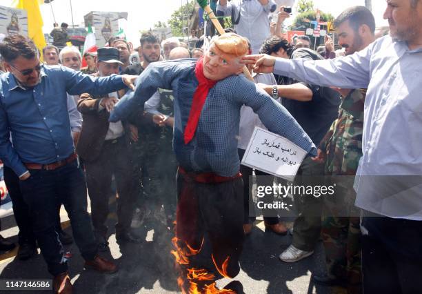 Iranians burn an effigy of US President Donald Trump during a parade marking al-Quds International Day in Tehran on May 31, 2019. - An initiative...