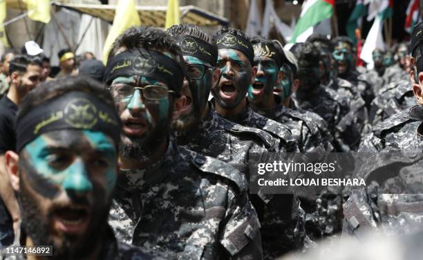 Palestinian members of the Saraya Al-Quds , the military branch of Islamic Jihad faction, march as they mark Al-Quds Day in the Syrian capital...