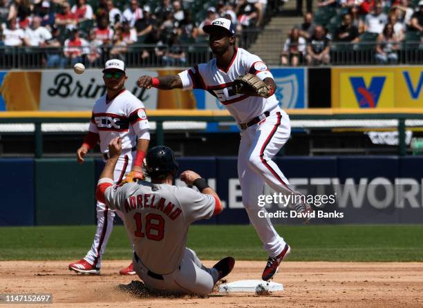Tim Anderson of the Chicago White Sox forces out Mitch Moreland of the Boston Red Sox at second base then throws to first base to complete a double...