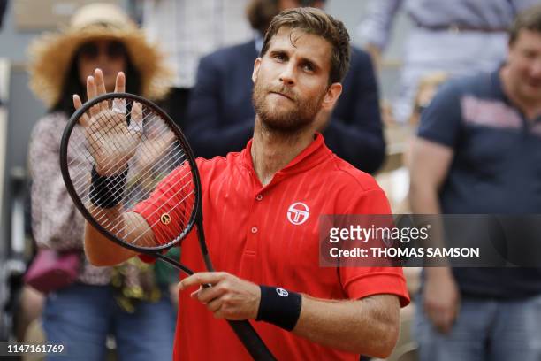 Slovakia's Martin Klizan celebrates after winning against France's Lucas Pouille during their men's singles second round match on day six of The...