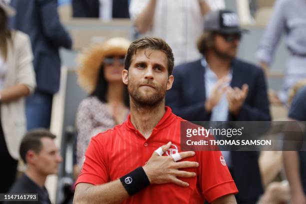 Slovakia's Martin Klizan celebrates after winning against France's Lucas Pouille during their men's singles second round match on day six of The...