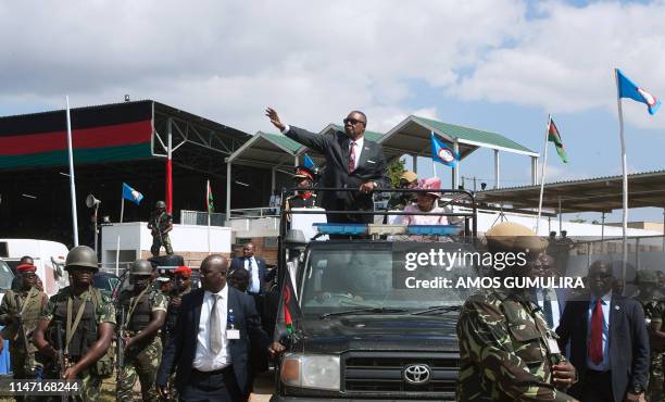 Malawis President elect Arthur Peter Mutharika , who was sworn in two days prior, waves at supporters as he leaves Kamuzu Stadium in Blantyre, May 31...