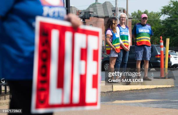 Clinic escorts stand in the parking lot as anti-abortion demonstrators hold a protest outside the Planned Parenthood Reproductive Health Services...