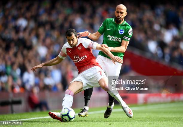 Henrikh Mkhitaryan of Arsenal is challenged by Bruno Saltor Grau of Brighton and Hove Albion during the Premier League match between Arsenal FC and...
