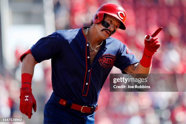 Derek Dietrich of the Cincinnati Reds reacts after hitting a solo home run, the team's third straight, in the first inning against the San Francisco...