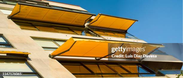 yellow awnings - awning stock pictures, royalty-free photos & images